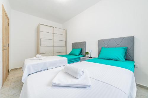 two beds in a room with blue and white at Prcanj Seaside Heaven in Prčanj
