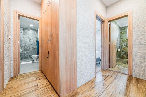 an empty hallway with wooden doors and a toilet at Prcanj Seaside Heaven in Prčanj