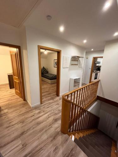 a hallway with a staircase and a living room at Ferienwohnung Marcello in Adenau