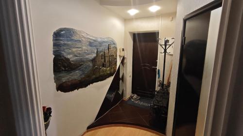 a bathroom with a painting of a city on the wall at Spacious apartment on Otakar Yarosh in Kharkiv