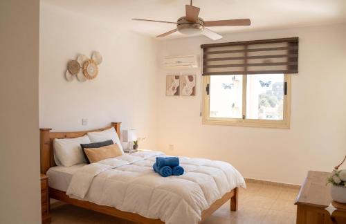 a bedroom with a bed with a blue stuffed animal on it at Sunshine Royal Seacrest- Prime Location Paphos with Pool in Paphos