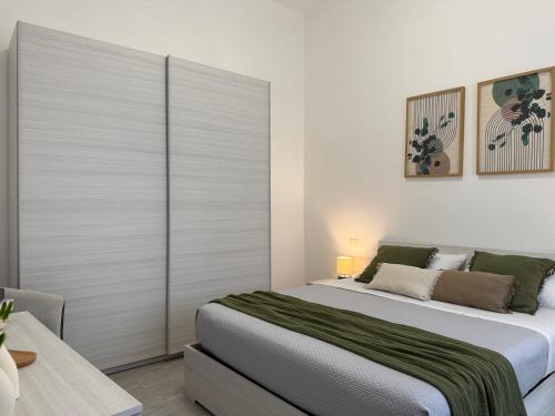 a bedroom with a large bed with a sliding door at Room 28 in Conversano