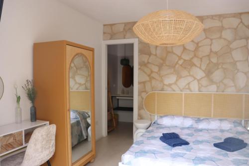 a bedroom with a bed with blue towels on it at Residència Mediterrània Alguer in Alghero