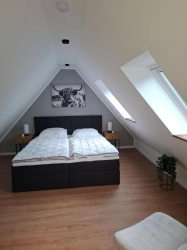 a bedroom with a bed in a attic at Ferienwohnung Hof Dittmer in Bleckede