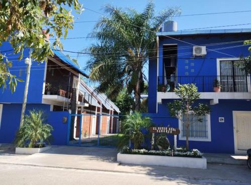 a blue building with a sign in front of it at El Sitio Azul Cabañas in Esquina