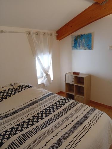 a bedroom with a large bed and a window at Charme - Centre historique de Die in Die