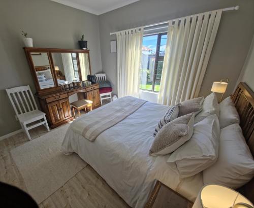 a bedroom with a bed with pillows and a window at Caledonia Guest Room in Trichardt