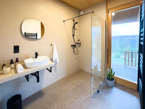 a bathroom with a sink and a shower at Öreg-kő 1478 in Bajót