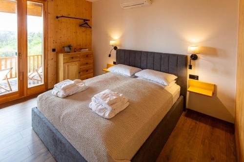 a bedroom with a bed with two towels on it at Öreg-kő 1478 in Bajót