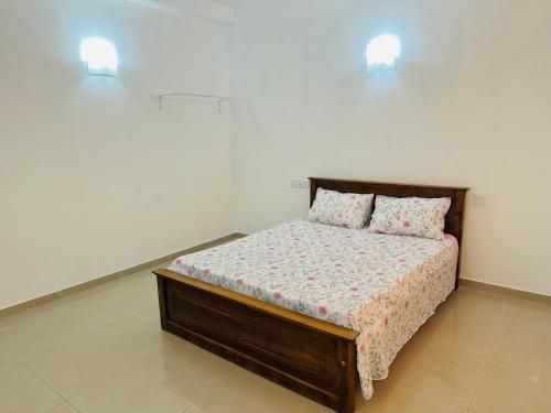 a bedroom with a bed with two pillows on it at La Margaritha Hotel & Banquet Hall in Udugampola