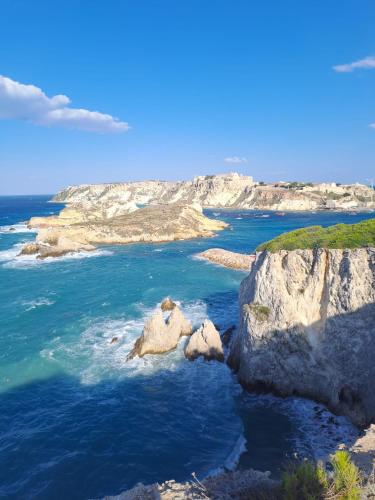 an island in the ocean with rocks in the water at Una piccola casa al mare in San Domino