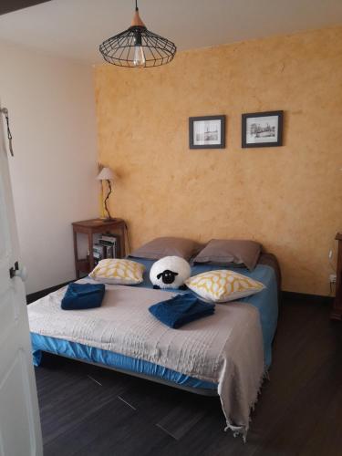 a bedroom with a bed with a stuffed animal on it at Chez Is-Mi in Chauriat