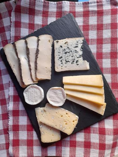 a plate of different types of cheese on a table at Chez Is-Mi in Chauriat