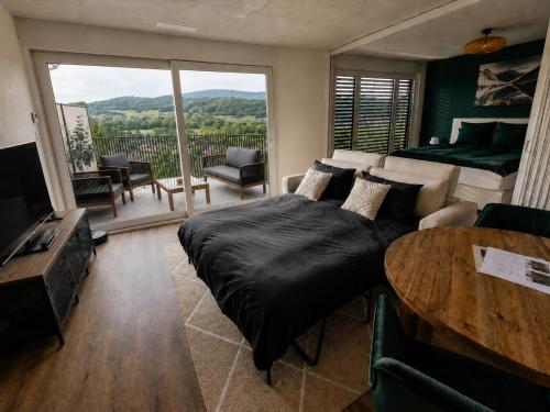 a bedroom with a large bed and a table at Luxury Home JuNa in Aarau