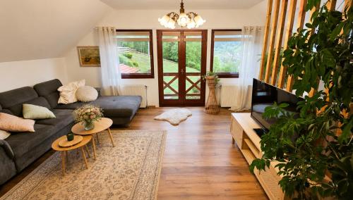a living room with a couch and a table at Apartmán pod Skalou in Vysoká nad Kysucou