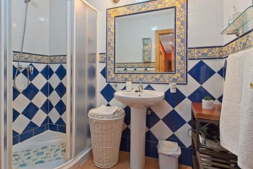 a bathroom with a sink and a shower and a mirror at La Cuadra in Cabornera