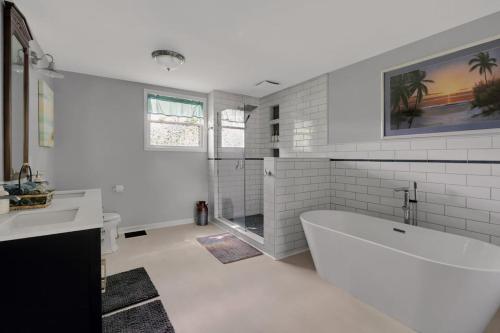 a white bathroom with a tub and a sink at Derby Dreams llc in Clarksville