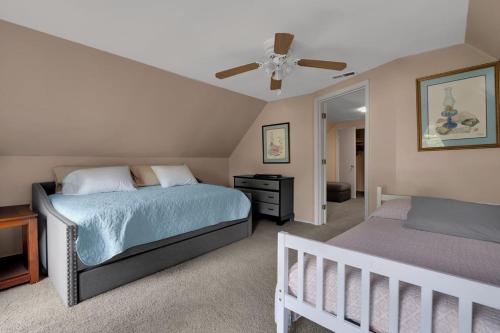 a bedroom with two beds and a ceiling fan at Derby Dreams llc in Clarksville