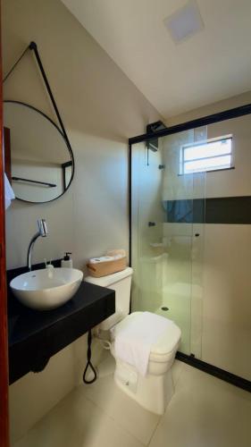 a bathroom with a toilet and a sink and a shower at Loft Duplex Moderno - 50m da Praia - Ar - Wi-Fi in Salinas da Margarida