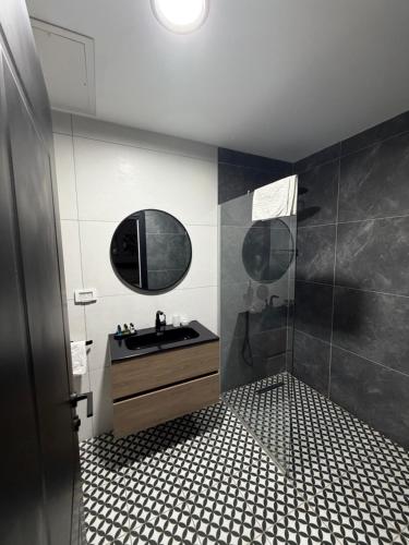 a bathroom with a sink and a mirror at בוטיק רפאל Boutique Rafael in Eilat