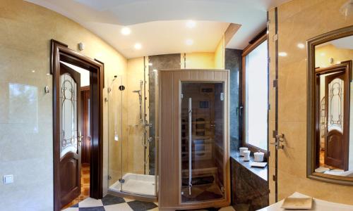 a bathroom with a shower and a glass door at Mazurska Tajemnica 1 in Łoje