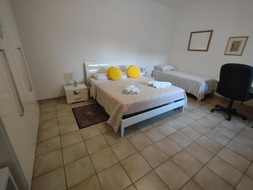 a bedroom with a bed with yellow pillows on it at Agli Ulivi in Filo