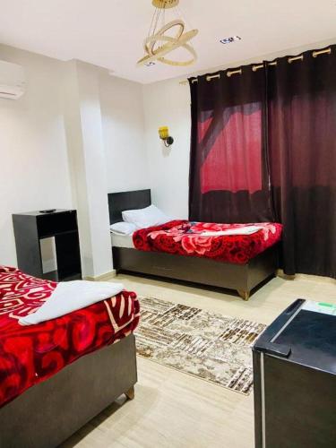 a bedroom with two beds and a window at Summer Land Hotel in Abu Simbel