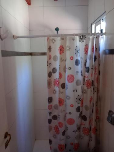 a shower with a shower curtain in a bathroom at La casita de Gorrión in Villa Ventana