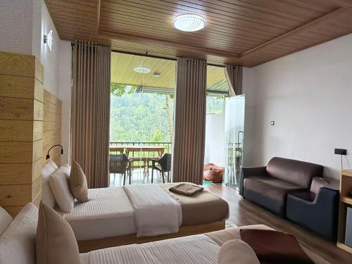 a bedroom with a bed and a couch and a window at Ever Green Mount in Ella