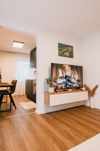 a living room with a fireplace and a table at Waldblick am Ring in Kelberg