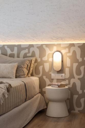 a bedroom with a bed and a table and a mirror at Vabel Skiathos in Skiathos