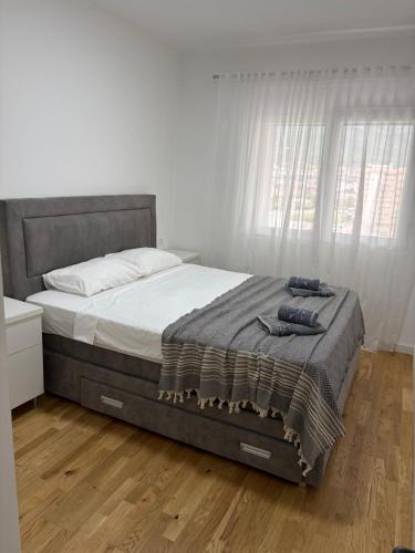 a bedroom with a large bed with a wooden floor at Sarah Central City Apartment-Bar in Bar
