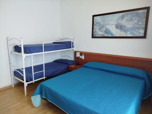 a bedroom with two bunk beds and a picture on the wall at Hotel Silva Frontemare PARK & BEACH-PLACE INCLUDED in Lido di Jesolo