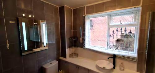 a bathroom with a sink and a window at Reigate - 1 Bed by Mobius Property Solutions in Reigate