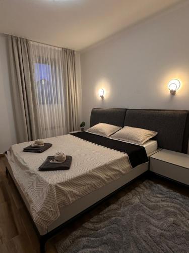 a bedroom with a large bed with two dishes on it at Vila Pogled in Novi Sad