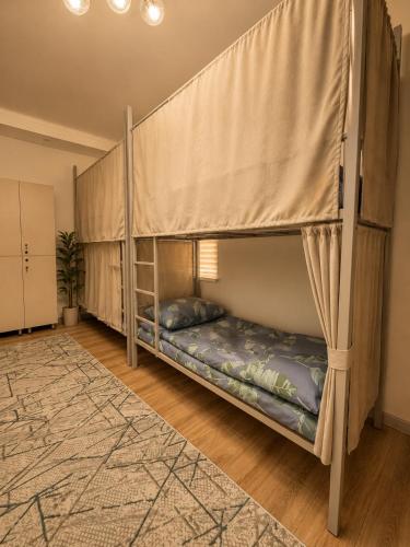 a bedroom with two bunk beds in a room at Babushka House Hostel in Bishkek