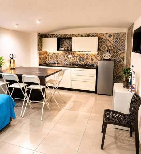 a kitchen with a dining room table and chairs at BASSA MAREA in Gaeta