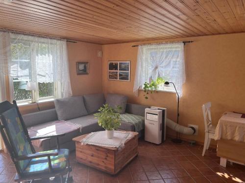 a living room with a couch and a table at Sweet guest house with a view in Sävsjö