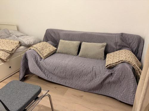 a couch with pillows on it in a room at Dorfblick Barweiler in Barweiler