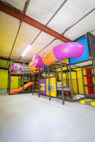 a play room with a bunch of slides at Hotel Vista Alegre in Barranquitas