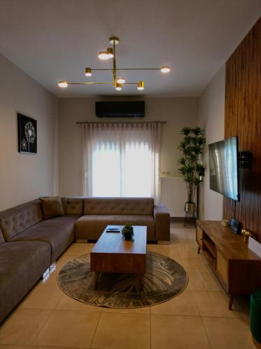 a living room with a couch and a coffee table at Asul Seaside Retreat in Stavros
