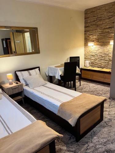 a hotel room with a bed and a desk with a chair at Dom Gościnny Pieniny, centrum Szczawnicy in Szczawnica