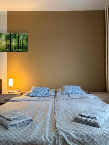 a bed with two towels on top of it at Casa Victoria in Pécs