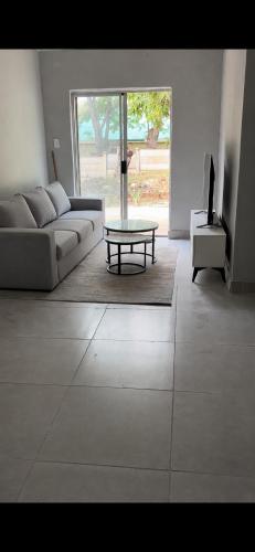 a living room with a couch and a coffee table at Mine Lux Rentals in Thabazimbi