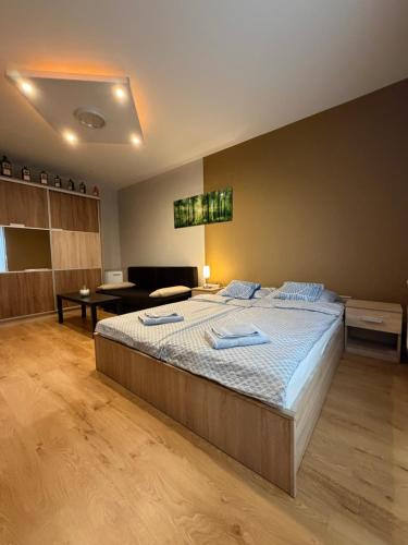 a bedroom with a large bed with blue towels on it at Casa Victoria in Pécs