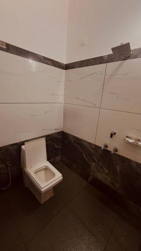 a bathroom with a toilet and a sink at Arackal in Trivandrum
