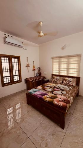 a bedroom with a large bed in a room at Arackal in Trivandrum