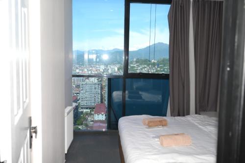 a hotel room with a bed and a large window at Batumi Skynest in Batumi