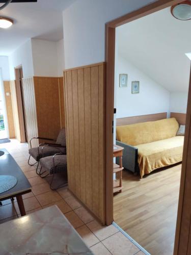 a room with a bedroom with a bed and a sliding door at Olimpia Pobierowo in Pobierowo