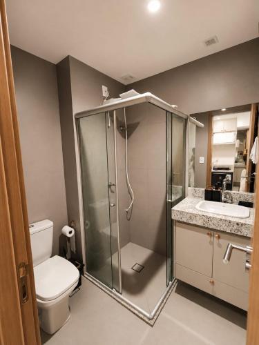 a bathroom with a shower and a toilet and a sink at VISTA MAR SPOT Barra in Salvador